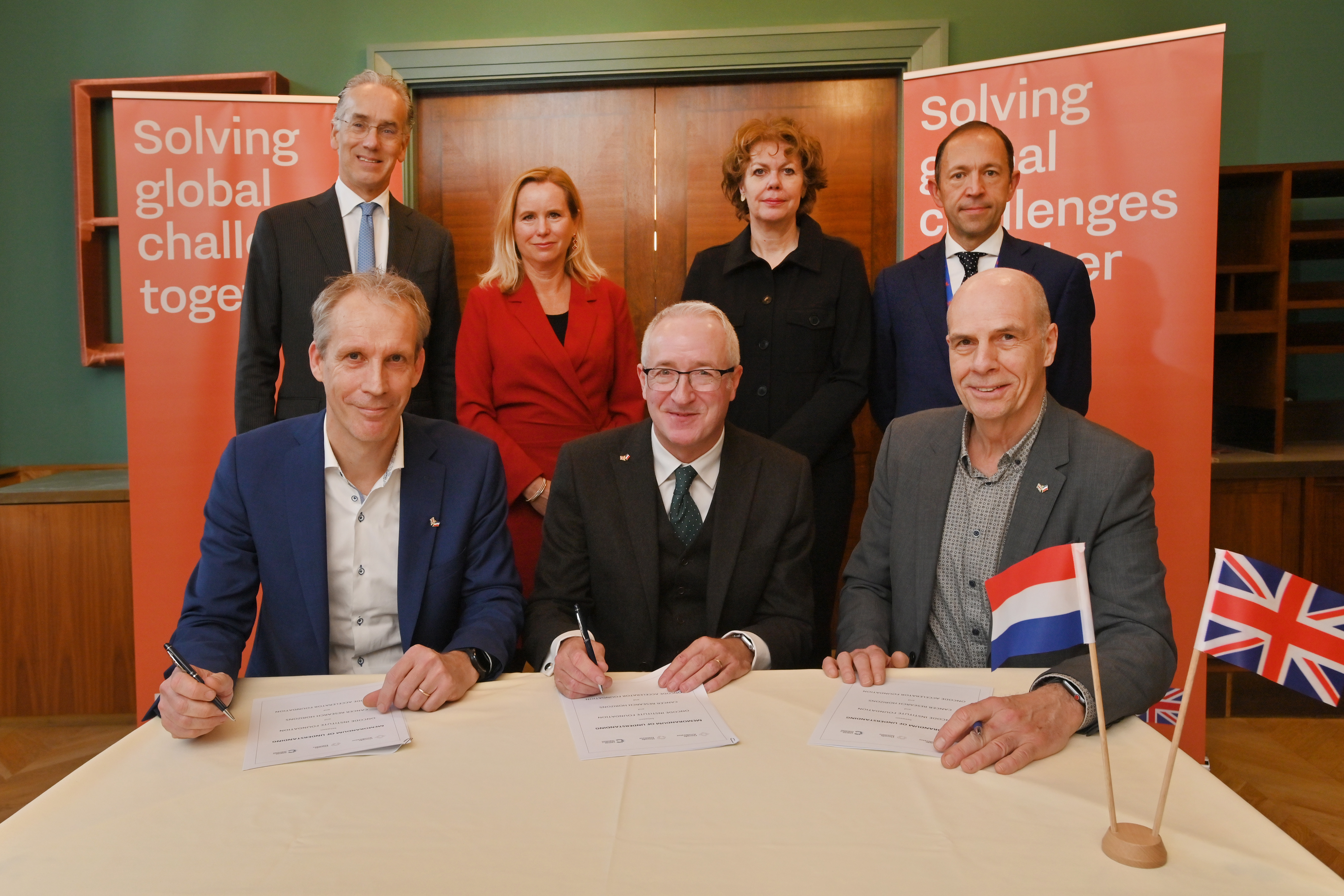 MoU Signing with Ambassador Paul Huijts; Minister Reinette Klever; Ingrid Thijssen. President VNO-NCW; Simon Banham, Country Director, Department for Business and Trade Netherlands. Bottom row, left to right: Jan Paul Medema, Scientific Director and Head of Oncode Institute; Tony Hickson, Chief Business Officer of Cancer Research UK and Cancer Research Horizons; Mark Krul, Chief Scientific Officer of Oncode Accelerator Foundation. Credit: PB Media