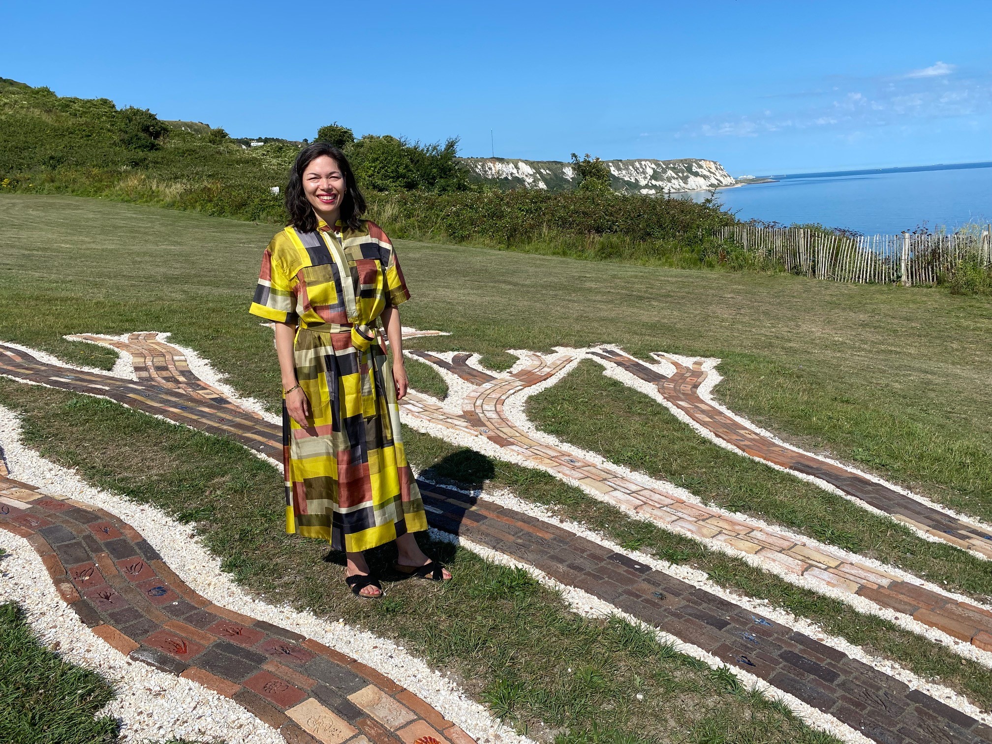Jennifer Tee standing in front of her artwork Oceans Tree of Life, that she created for Folkestone Triennial 2025.