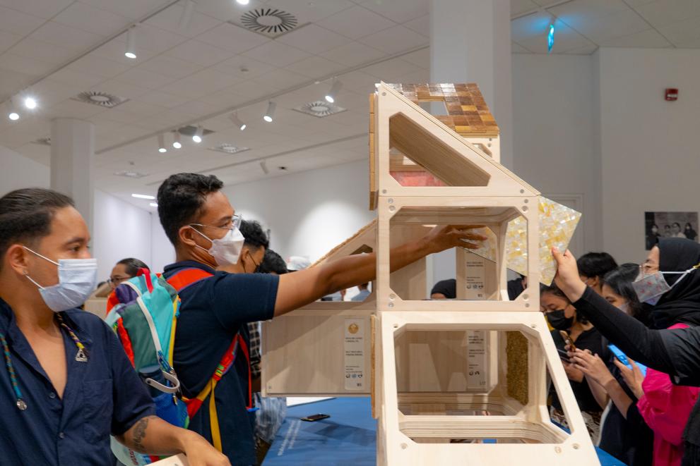 Visitors interact during the opening of Building with Nature Exhibition by Company New Heroes