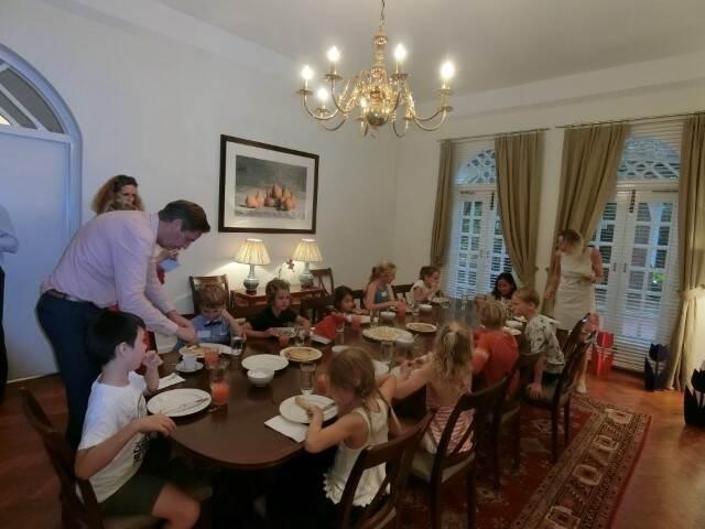 Winners of the Embassy cycling drawing contest from the Hollandse School Singapore eating pancakes at the Residence, December 2017