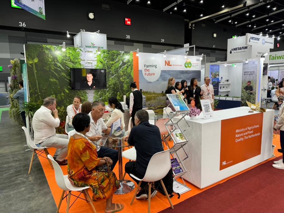 People gathering at a booth at Horti Asia 2024